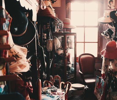 old closet filled with old clothes hats shoes