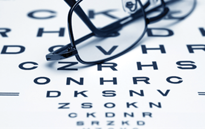black and white eye chart and pair of rimmed glasses